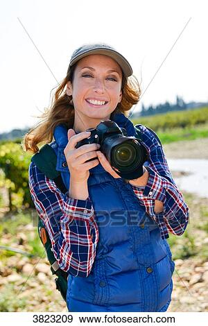cheerful young woman hiking and taking pictures with her reflex single lens camera- Cepage Grenache, Chateauneuf du Pape, cotes du Rhone, France View Large Photo Image Stock Photo - cheerful young woman hiking and taking pictures with her reflex single lens camera- Cepage Grenache, Chateauneuf du Pape, cotes du Rhone, France. Fotosearch