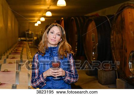 cheerful young woman oenologist tasting a glass of wine in cellar with wine barrel in background- Cepage Grenache, Chateauneuf du Pape, cotes du Rhone, France View Large Photo Image Stock Photography - cheerful young woman oenologist tasting a glass of wine in cellar with wine barrel in background- Cepage Grenache, Chateauneuf du Pape, cotes du Rhone, France. Fotosearch
