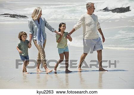 Children walking with their grandparents on the beach View Large Photo Image Stock Image - Children walking with their grandparents on the beach. Fotosearch