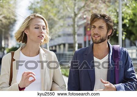 Stock Image - Close-up of a couple walking. Fotosearch