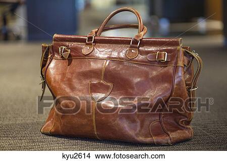 Picture - Close-up of a leather purse on an airport. Fotosearch
