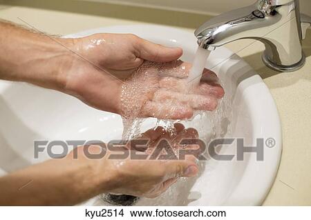 Picture - Close-up of a man washing his hands. Fotosearch