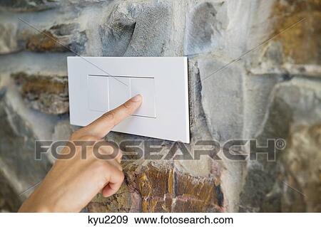 Close-up of a person's hand pressing a light switch View Large Photo Image Stock Photo - Close-up of a person's hand pressing a light switch. Fotosearch