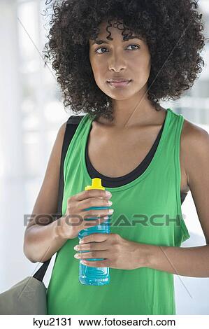 Close-up of a woman holding a water bottle View Large Photo Image Stock Image - Close-up of a woman holding a water bottle. Fotosearch