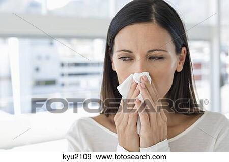 Stock Photo - Close-up of a woman sneezing. Fotosearch