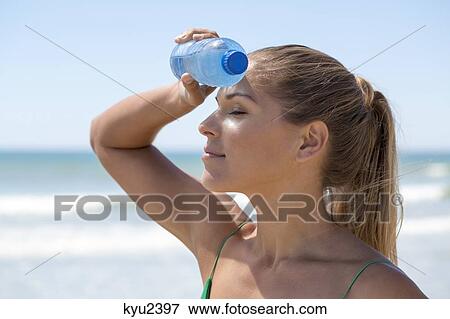 Close-up of a woman with a water bottle View Large Photo Image Stock Photo - Close-up of a woman with a water bottle. Fotosearch