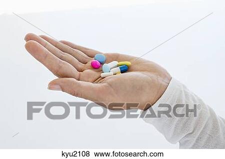 Close-up of a woman's hand holding medicines View Large Photo Image Stock Photo - Close-up of a woman's hand holding medicines. Fotosearch
