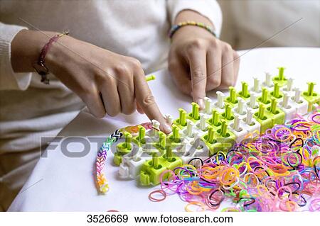 Close-up of hands making elastic bracelets, rainbow loom View Large Photo Image Stock Photo - Close-up of hands making elastic bracelets, rainbow loom. Fotosearch
