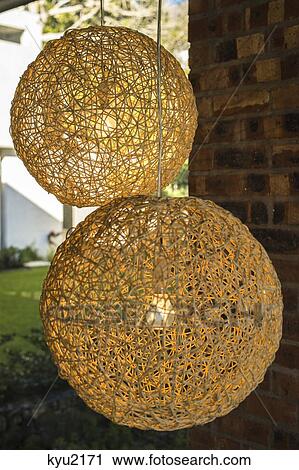 Stock Image - Close-up of nest shaped lamps hanging from ceiling. Fotosearch