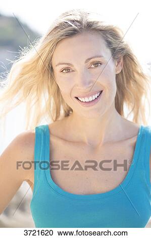 Close-up of smiling blond woman View Large Photo Image Stock Image - Close-up of smiling blond woman. Fotosearch