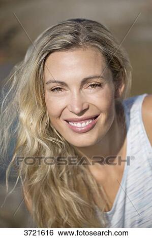 Close-up of smiling blond woman View Large Photo Image Stock Photograph - Close-up of smiling blond woman. Fotosearch