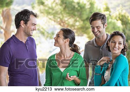 Stock Image - Close-up of smiling friends. Fotosearch