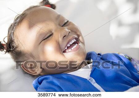 Picture - Close-up of smiling Moroccan girl. Fotosearch
