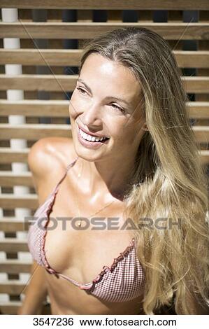 Close-up of smiling young woman View Large Photo Image Stock Photograph - Close-up of smiling young woman. Fotosearch