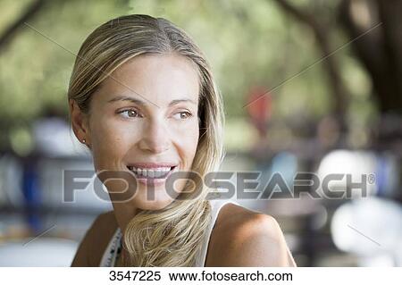Stock Photography - Close-up of smiling young woman. Fotosearch