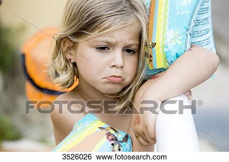 Stock Photograph - Close-up of sulky little girl. Fotosearch