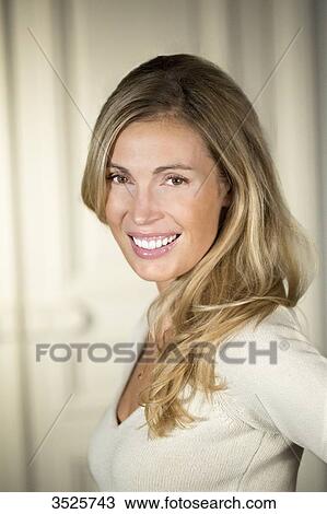 Close-up of young woman smiling View Large Photo Image Stock Image - Close-up of young woman smiling. Fotosearch