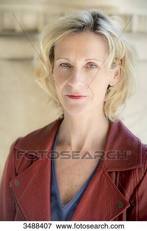 Corinne, 50-year-old woman, smiling slightly, looking at the lens. View Large Photo Image Stock Photo - Corinne, 50-year-old woman, smiling slightly, looking at the lens.. Fotosearch
