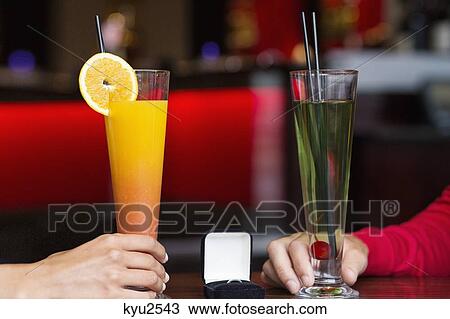 Stock Image - Couple drinking cocktail in a restaurant. Fotosearch