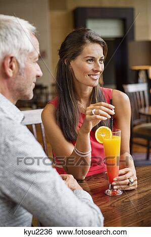 Stock Photograph - Couple enjoying drink in a restaurant. Fotosearch
