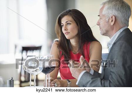 Stock Image - Couple enjoying red wine in a restaurant. Fotosearch