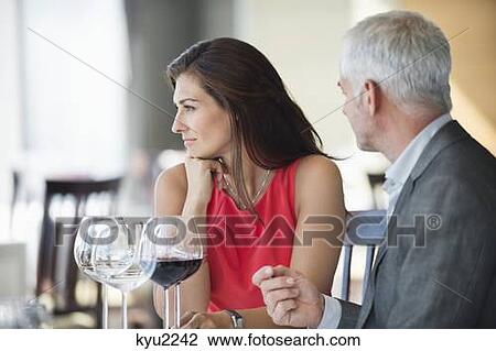 Couple enjoying red wine in a restaurant View Large Photo Image Stock Image - Couple enjoying red wine in a restaurant. Fotosearch