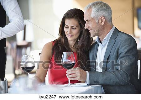 Stock Photo - Couple enjoying red wine in a restaurant. Fotosearch