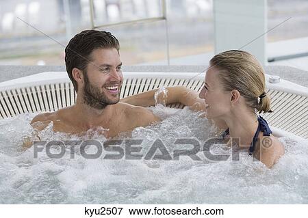 Stock Photo - Couple in a hot tub. Fotosearch
