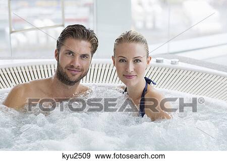 Stock Photo - Couple in a hot tub. Fotosearch