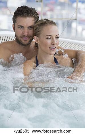 Stock Photography - Couple in a hot tub. Fotosearch