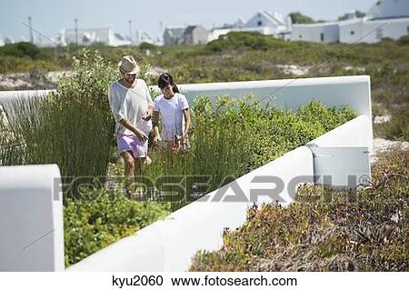 Couple looking at plants in a garden View Large Photo Image Stock Image - Couple looking at plants in a garden. Fotosearch