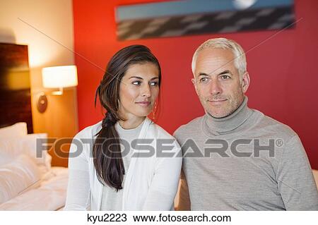 Couple sitting together in a hotel room View Large Photo Image Stock Image - Couple sitting together in a hotel room. Fotosearch