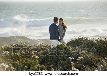 Couple standing on the beach View Large Photo Image Stock Image - Couple standing on the beach. Fotosearch