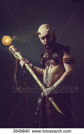 Creature holding a magic stick View Large Photo Image Stock Image - Creature holding a magic stick. Fotosearch