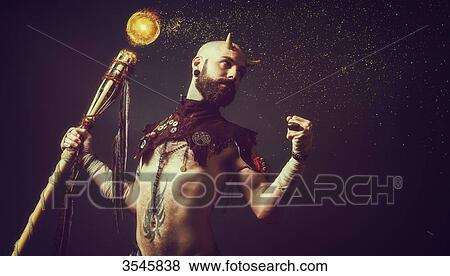 Stock Photo - Creature holding a magic stick. Fotosearch