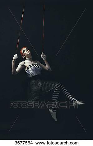 Dancing doll swings, staring into the void View Large Photo Image Picture - Dancing doll swings, staring into the void. Fotosearch