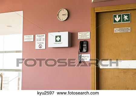 Emergency exit door with first aid kit and emergency phone View Large Photo Image Stock Photo - Emergency exit door with first aid kit and emergency phone. Fotosearch
