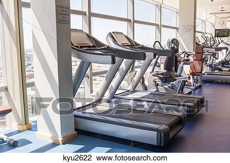 Stock Image - Exercise machines in a gym. Fotosearch