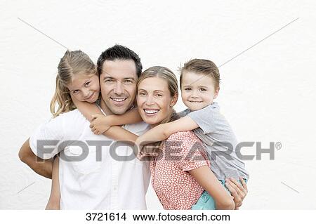 Picture - Family portrait, parents with their children on their back. Fotosearch