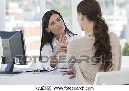 Female doctor examining a patient View Large Photo Image Stock Image - Female doctor examining a patient. Fotosearch