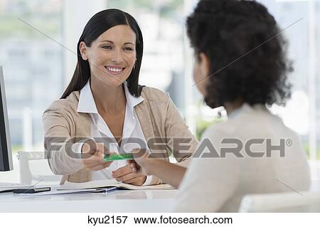 Female doctor giving a health insurance card to a patient View Large Photo Image Stock Photo - Female doctor giving a health insurance card to a patient. Fotosearch