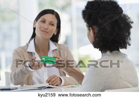 Female patient giving health insurance card to a doctor View Large Photo Image Stock Photo - Female patient giving health insurance card to a doctor. Fotosearch