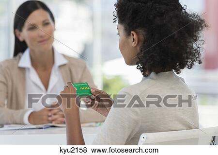 Female patient looking at a health insurance card View Large Photo Image Stock Photo - Female patient looking at a health insurance card. Fotosearch