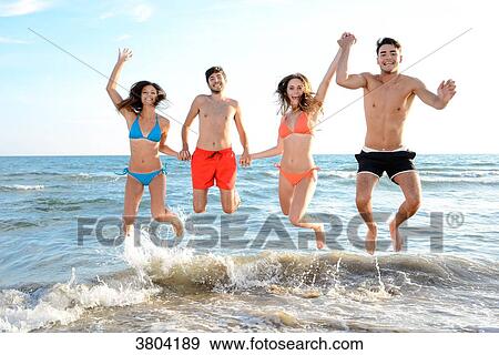 France, 4 young friends pose in front of the sea while jumping in the air, looking very joyous. View Large Photo Image Stock Photo - France, 4 young friends pose in front of the sea while jumping in the air, looking very joyous.. Fotosearch