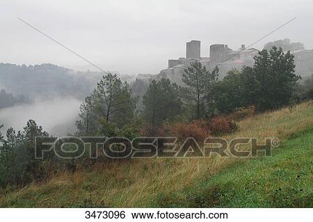 Stock Photograph - France, Ardeche, Montreal, the village and the castle in the mist, landscape in the mist,. Fotosearch