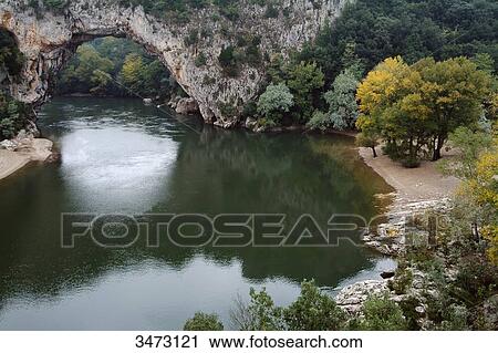 Stock Image - France, Ardeche, Vallon Pont d'arc, Ardeche Gorges, Pont d'Arc on the Ardeche river.. Fotosearch