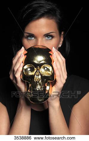 France, brown young woman in studio with skull View Large Photo Image Stock Photograph - France, brown young woman in studio with skull. Fotosearch