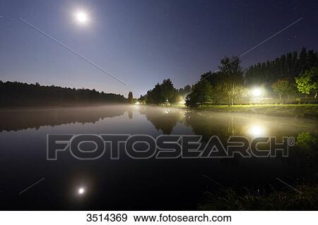 France, Burgundy, Yonne. Saint Sauveur in Puisaye. The pond of Joumiers by night, in lunar atmosphere. View Large Photo Image Stock Photo - France, Burgundy, Yonne. Saint Sauveur in Puisaye. The pond of Joumiers by night, in lunar atmosphere.. Fotosearch