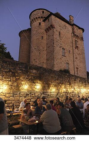 Stock Photo - France, Center of France, Curemonte, at the feet of the Saint Hilaire castle, the Thursdays of Curemonte, each bought at the market what they need to cook a meal on berbecues offered by the municipality. Fotosearch