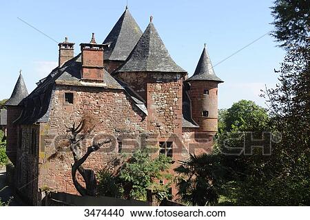 Stock Image - France, Center of France, Collonge-La-Rouge owes its name to the red stone which has been used for its construction. The 'Quercy karst', architecture, house, tower, the castel of Vassignac. Fotosearch